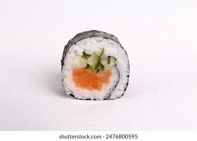 A freshly made sushi roll with fish and vegetables isolated on the white background, close-up