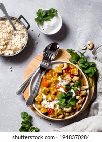 Freshly Made, Warming, Cosy Vegan Tofu Chickpea And Mango Curry Served With Fresh Coriander, Chili And Yogurt, With A Side Plate Of Warm Jasmine Rice And Plant Based Yogurt.