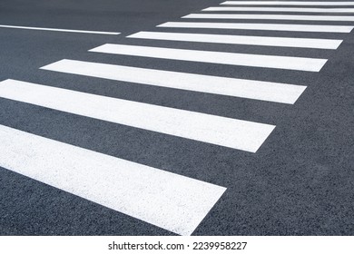 Freshly painted crosswalk. Asphalt marked on the road. new pedestrian zebra background in the city street - Powered by Shutterstock