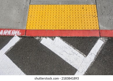 Freshly Painted White Crosswalk Marking Leading To A Yellow Painted ADA Sidewalk Access In A Fire Lane
