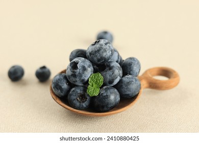 Freshly Picked Blueberries on Wooden Spoon, Juicy and fresh Blueberries with Mint Leaves. Bilberry Rich of Antioxidant Concept for Healthy Eating  - Powered by Shutterstock