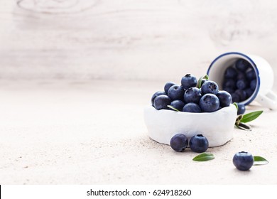 Freshly picked blueberries in a white vintage ceramic bowl. Selective focus, Free text space. - Powered by Shutterstock