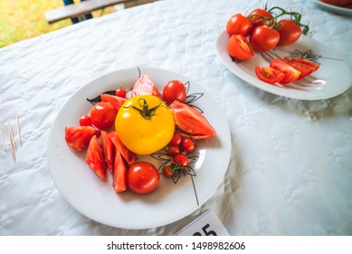 Freshly picked tomatoes, served on a plate on the table as decoration - Shutterstock ID 1498982606