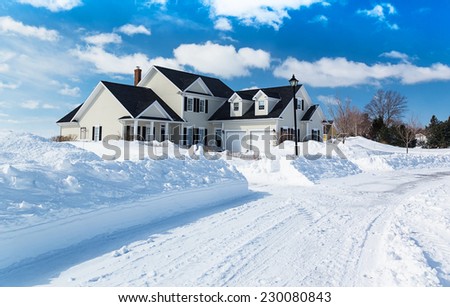 A freshly plowed road in America suburbia after a snow storm.