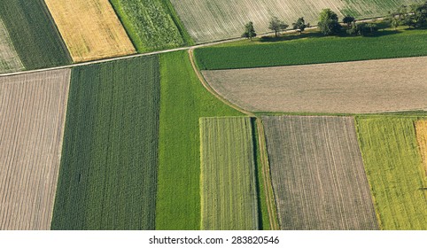 Freshly Plowed And Sowed Farming Land From Above, Neatly Cultivated In Non-urban Agricultural Area, Textured Effect And Background. Food Production Industry, Arable Land Concept.