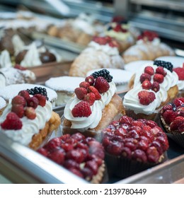 Freshly Prepared Desserts In The Pastry Counter. Desserts With Cream And Strawberries