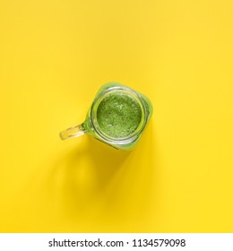 Freshly Prepared Green Smoothie On Yellow Background. Clean Eating. Overhead Food Shots