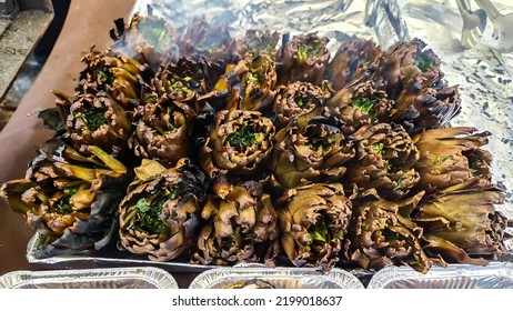 Freshly Prepared Grilled Artichokes At The Street Market In The Streets Of Catania, Sicily, Italy, Europe. Stall With Local Types Of Fresh Vegetables.Traditional Italian Street Food.