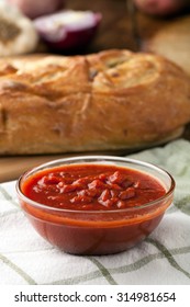 Freshly Prepared Pasta Or Pizza Sauce Marinara In A Glass Bowl. Bread In Background.