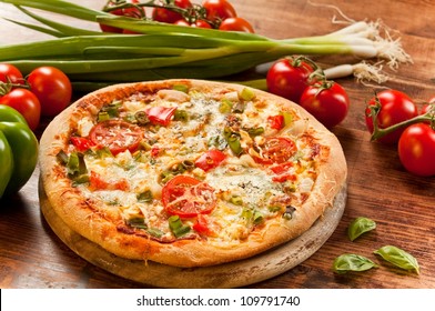 freshly prepared pizza, baked with herbs and vegetables