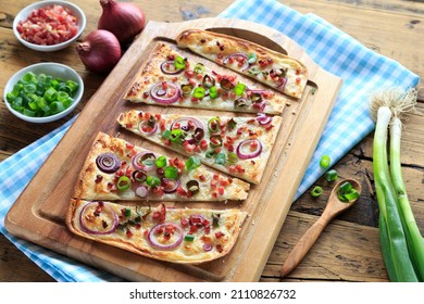 Freshly Prepared Tarte Flambée On Wooden Board