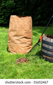 Freshly Raked Backyard, With Rake, Leaves And Recycling Yard Waste Paper Bag