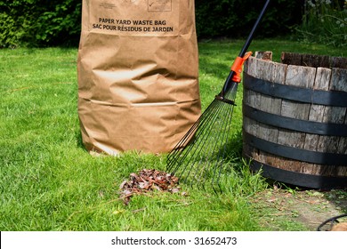 Freshly Raked Backyard, With Rake, Leaves And Recycling Yard Waste Paper Bag