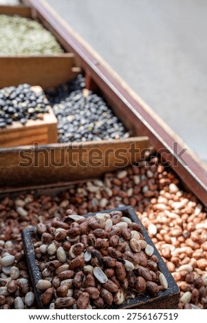 freshly roasted peanuts and assorted nuts on a traditional handcart stall at gongju sanseong market.