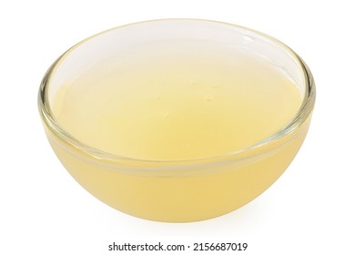 Freshly Squeezed Lemon Juice In A Glass Bowl Isolated On White.