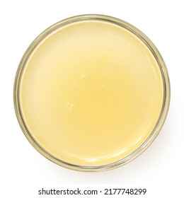 Freshly Squeezed Lemon Juice In A Glass Bowl Isolated On White. Top View.