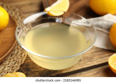 Freshly Squeezed Lemon Juice In Glass Bowl On Wooden Table