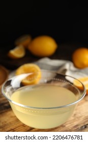 Freshly Squeezed Lemon Juice In Glass Bowl On Wooden Table