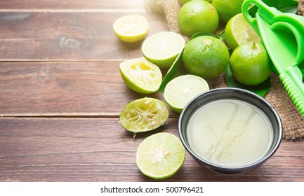 freshly squeezed lime juice with lime fruits on wood table