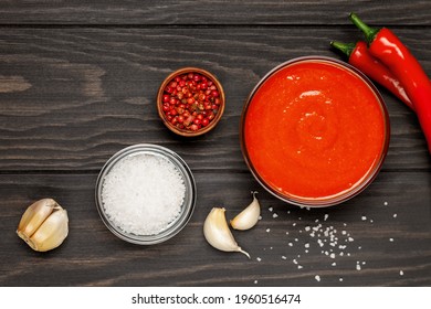 Freshly Sriracha Hot Chilli Sauce In Bowl On Wooden Background. Top View