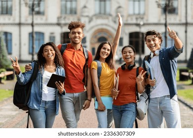 Freshmen Orientation Concept. Group Of First Year Students With Workbooks Posing Together Outdoors, Happy Multiethnic Young People Standing Near University Building And Smiling At Camera - Shutterstock ID 2336307309