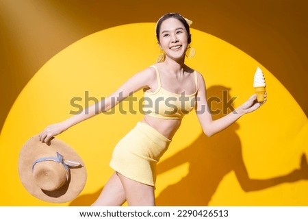 freshness delightful summer vacation people concept,asia adult woman in swimwear enjoy movement walking hand hold sunday soft serve icecream sweet desert smiling cheerful shooting on yellow background