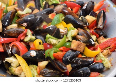 Freshwater Boiled Mussels Cooking As A Stir Fry With Organic Vegetables In A Large Silver Wok 