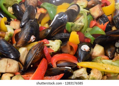 Freshwater Boiled Mussels Cooking As A Stir Fry With Organic Vegetables In A Large Silver Wok 