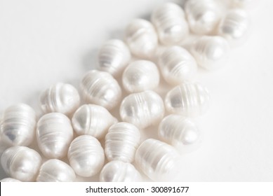 Freshwater Ringed Pearls.  The Pearls Are White In Color With An Irregular Oval Shape And Irregular Ring Pattern.