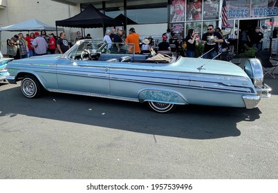 FRESNO, UNITED STATES - Apr 03, 2021: A Profile Of A Classic Blue Colored Impala Low Rider Car With Custom Graphic Art Designs On It Parked Outside At A Classic Car Show In Ca   2021