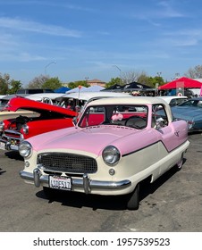 FRESNO, UNITED STATES - Apr 03, 2021: A Front View Photo Of A Beautiful Pink And White Classic Nash Car Parked Outside In Car Show In Ca  April 2021 Against A Blue Sky