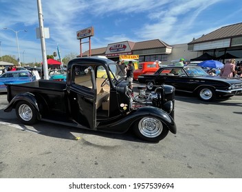 FRESNO, UNITED STATES - Apr 03, 2021: A Side Profile View Of An All Black Classic Pickup Truck With Doors Open At A Car Show Outside On A Sunny Day In Ca  April 2021