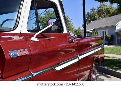 FRESNO, UNITED STATES - Oct 09, 2021: A Closeup Of A Wine Colored 1965 Classic C-10 Chevy Pickup Truck And White Top With Hood Up