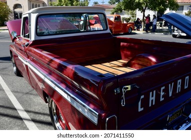 FRESNO, UNITED STATES - Oct 09, 2021: A Closeup Of A Wine Colored 1965 Classic C-10 Chevy Pickup Truck And White Top With Hood Up