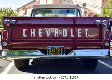 FRESNO, UNITED STATES - Oct 09, 2021: A Closeup Of A Wine Colored 1965 Classic C-10 Chevy Pickup Truck And White Top With Hood Up