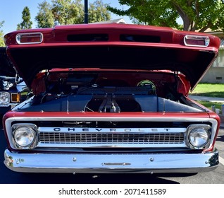 FRESNO, UNITED STATES - Oct 09, 2021: A Closeup Of A Wine Colored 1965 Classic C-10 Chevy Pickup Truck And White Top With Hood Up