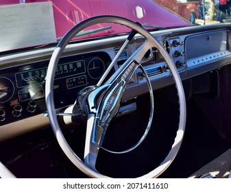 FRESNO, UNITED STATES - Oct 09, 2021: A Closeup Of Steering Wheel Wine Colored Classic C10 Chevy Pickup Truck And White Top With Hood Up