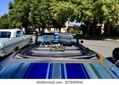 FRESNO, UNITED STATES - Oct 09, 2021: Blue Custom Colored 1965 Chevy Impala Convertible With Black And Gray Colored Leather Interior With Top Up At A Car Show In CA  2021