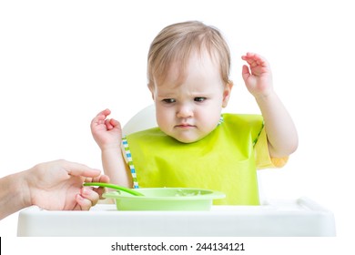 fretful child sitting in chair refuses to eat