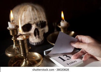 Friday 13th on a calendar with candles and a creepy skull