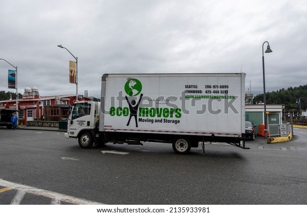 Friday Harbor, WA USA - circa\
November 2021: View of an Eco Movers moving truck fresh off the\
Washington State Ferry, making its way to a customer\'s new\
home.