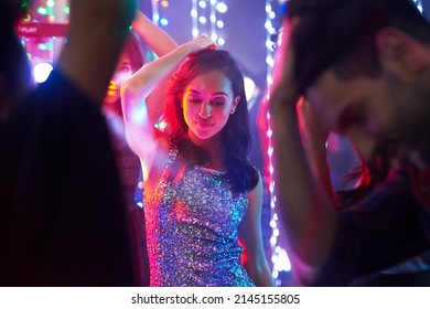 Friday Night Fun. Shot Of A Group Of Young People Having Fun On The Dancefloor In A Nightclub.