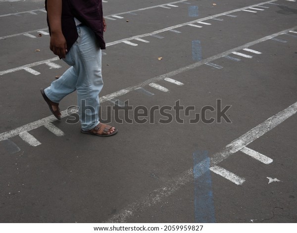 Friday, October 15, 2021. Gondangdia ward,\
Central Jakarta, Indonesia. Prayer divider marking at the parking\
lot of Cut Meutia Mosque, An old Islamic prayer building which\
originally a Dutch\
property.