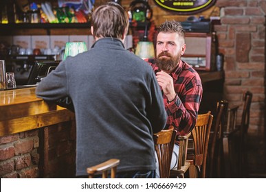 Friday Relaxation In Pub. Friends Relaxing In Pub. Friendly Conversation With Stranger. Hipster Brutal Bearded Man Spend Leisure With Friend Bar Counter In Pub. Men Relaxing In Pub. Weekend Leisure.