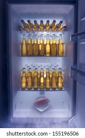Fridge full of cold beer with one lonely carrot / Man fridge concept