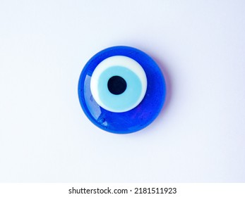 Fridge Magnet Souvenir In Shape Of Blue Evil Eye Nazar Boncuk Isolated On White Background. Travel To Turkey Concept. Top View Flat Lay Close Up, Copy Space