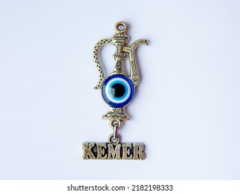 Fridge Magnet Souvenir In Shape Eastern Turkish Jug With Blue Evil Eye Nazar Boncuk And Inscription Kemer Isolated On White Background. Travel To Turkey Concept. Top View Flat Lay Close Up, Copy Space