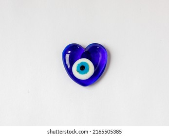 Fridge Magnet Souvenir In Shape Of Heart From Blue Evil Eye Nazar Boncuk Isolated On White Background. Love Travel To Turkey Concept. Top View Flat Lay Close Up, Copy Space