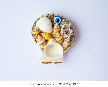 Fridge Magnet Souvenir In Shape Of Sea Shells With Blue Evil Eye Nazar Boncuk Isolated On White Background. Travel To Turkey Concept. Top View Flat Lay Close Up, Copy Space