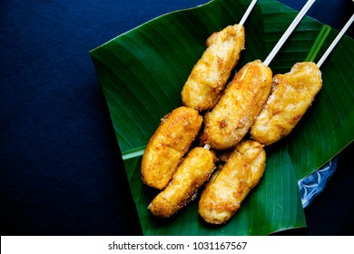 Fried banana on banana leaf plate. Philippine dessert banana cue. Golden banana on stick served for food. Tropical resort breakfast. Exotic island lifestyle. Tropical dessert. South Asia dish flat lay